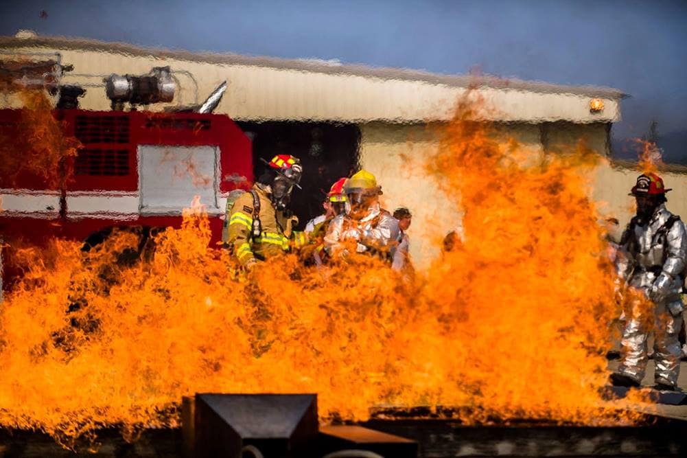As part of their emergency services training, the Vandenberg Space Force Base Fire Department work amid flames in a live fire demo.