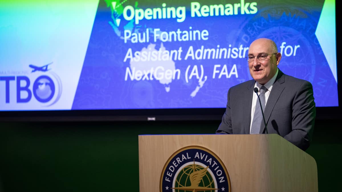 Paul Fontaine, acting assistant administrator for NextGen, conducts opening remarks for the inaugural Multi-Regional Trajectory Based Operations (MR TBO) demonstration flight event. 