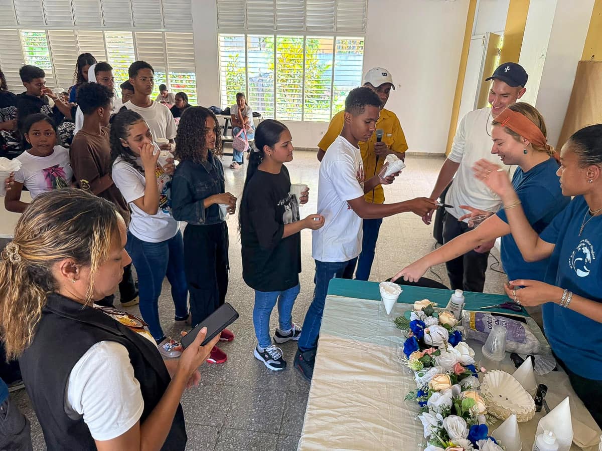 Students Ryan Croasdell, Parisse Goutier and Ethan Kaminsky lead local high school students in a water filter competition, illustrating the importance of clean water.