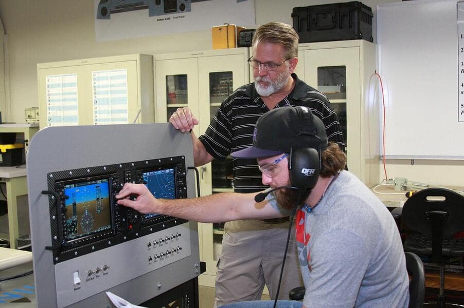 Professor Neil Fulbright works with an aviation line maintenance student in the Avionics Laboratory