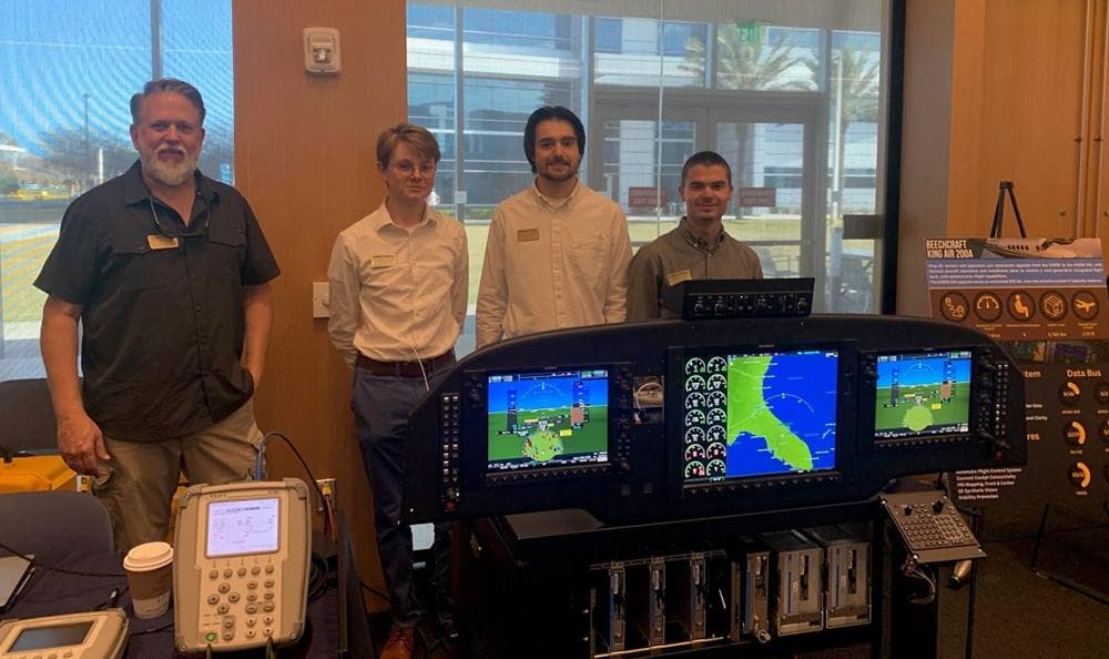 Aviation Maintenance Science professor Neill Fulbright poses with students Merritt Green, Elias Wiley and Tyler Mcqueen, who contributed to the Capture the Flag competition