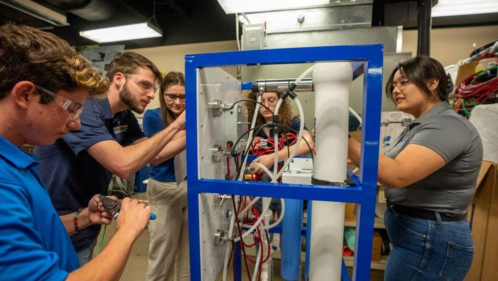 Embry-Riddle students work on a solar-powered water purification system that they will install during a trip to the Dominican Republic in May