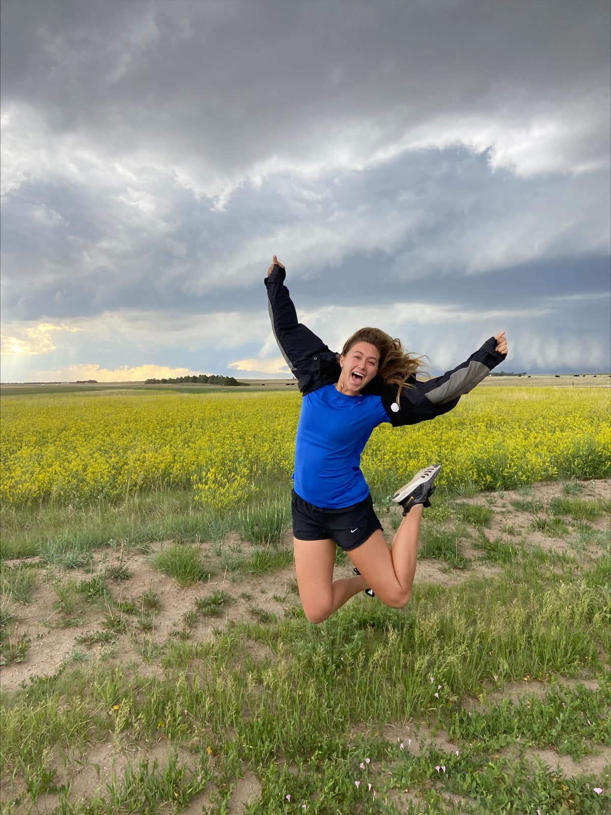 Woman jumps as a storm rolls in.