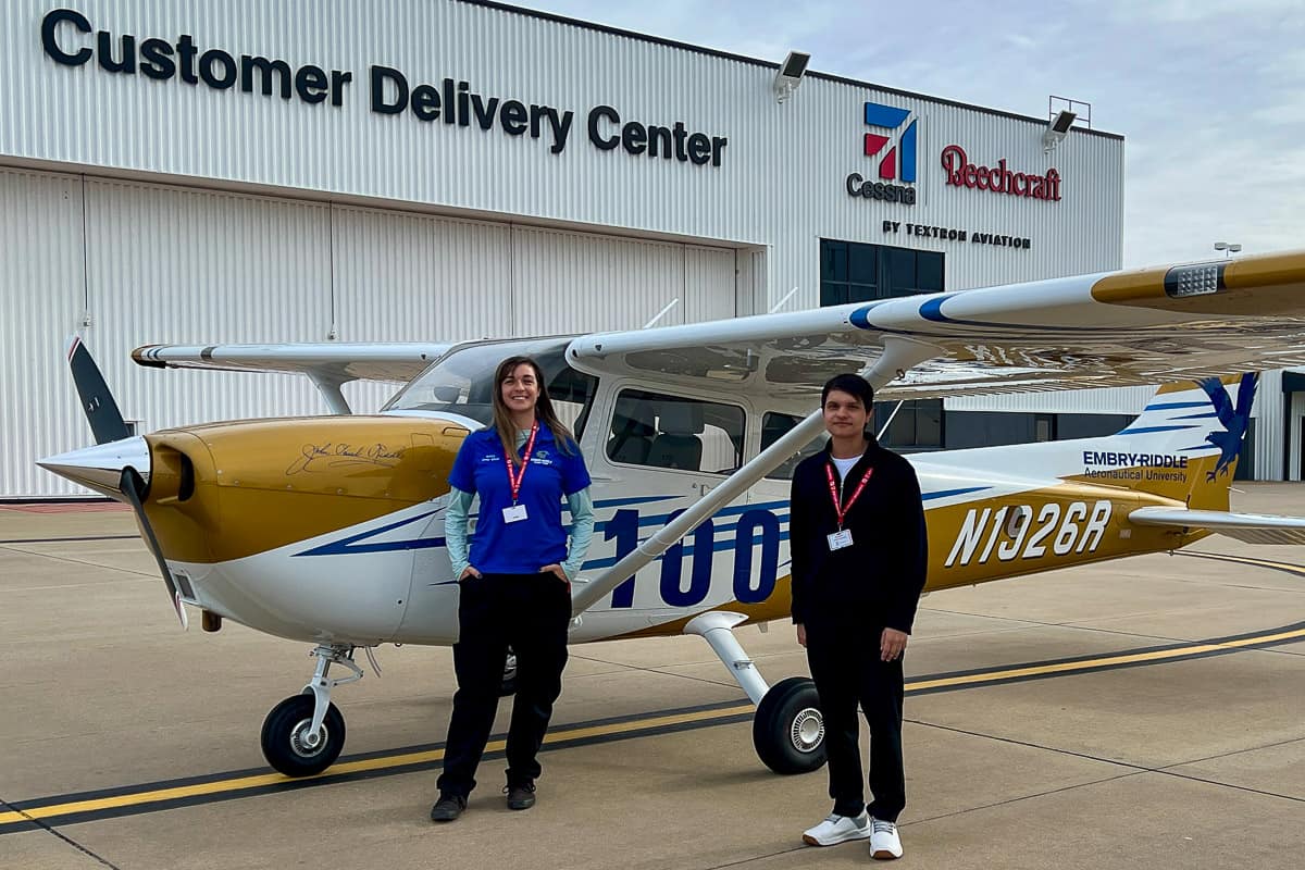 Embry-Riddle Aircraft Technician Korry Noyes and Flight Instructor Rafael Dubena in front of Cessna factory