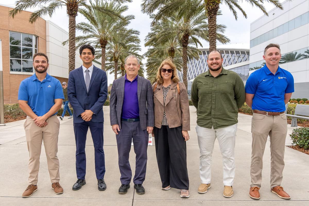 Former Embry-Riddle President Steve Sliwa and his wife, Nancy, stand with three students