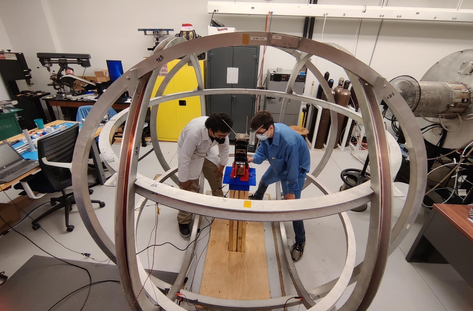 Students work inside a Helmholtz-Cage