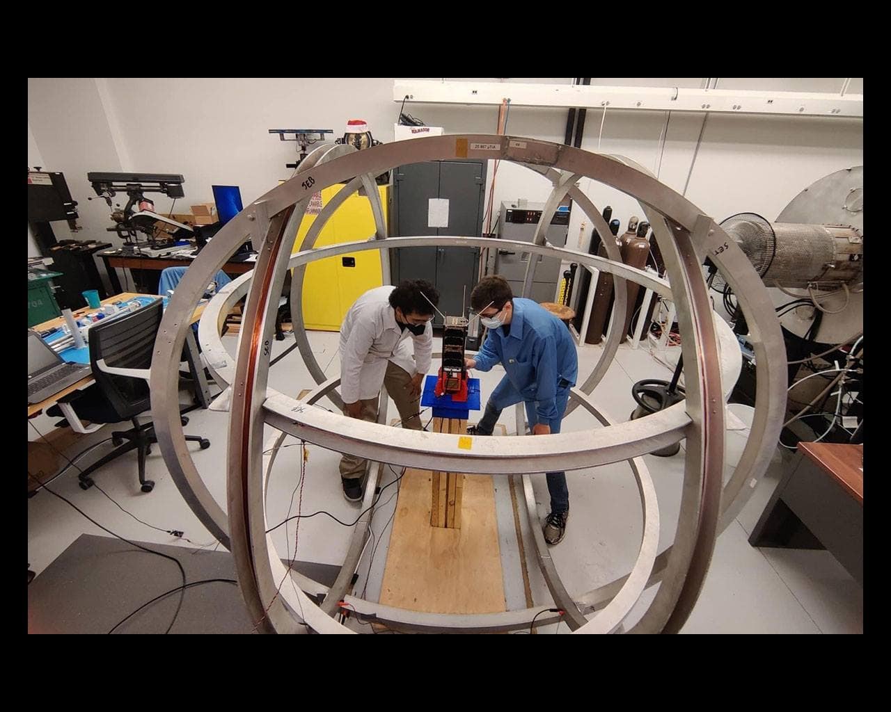 Students work inside a Helmholtz-Cage