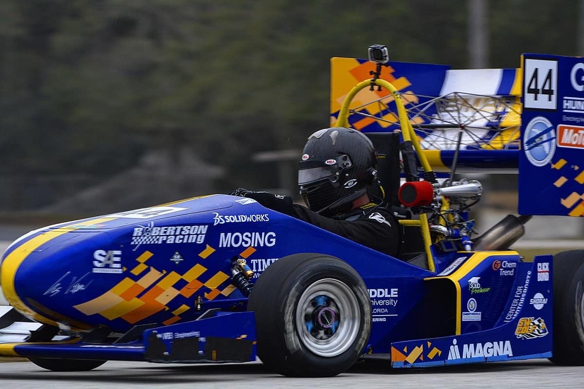 Driver seated in blue racecar