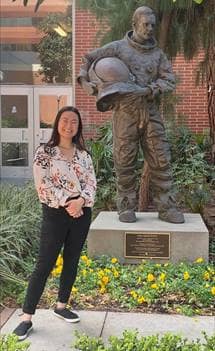 Olivia Siu poses with a statue of Neil Armstrong