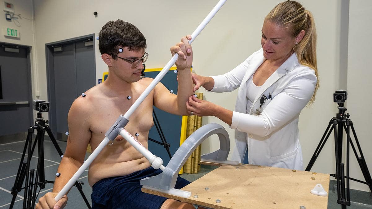 Dr. Christine Walck sticks diodes on graduate student James Palmer