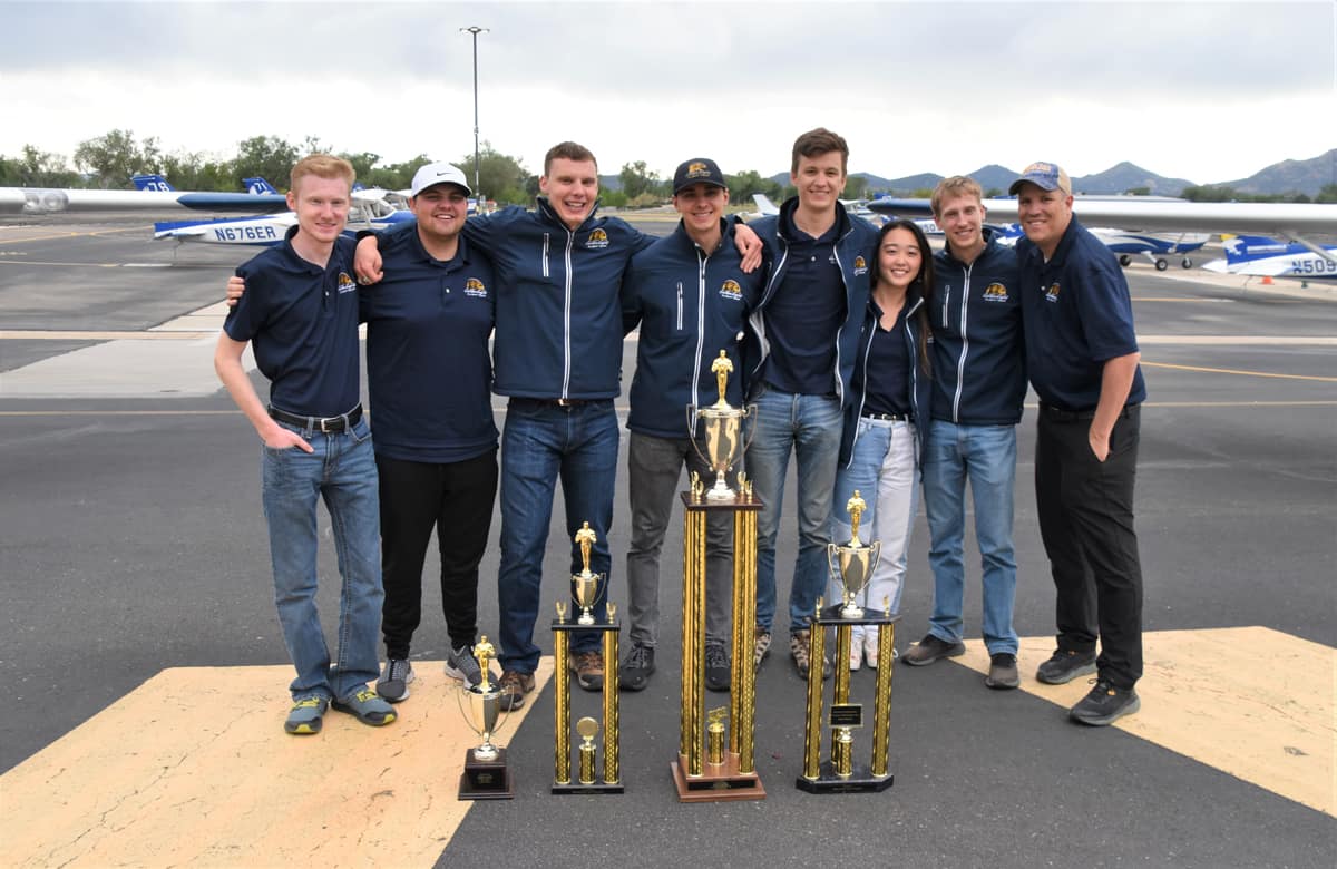 Golden Eagle Flight Team seniors: Camden Dellar, Hayden Morse, Gabriel Witt, George Fiscu, Logan Haynes, Karen Lau and Kenrick Vail, with Head Coach Shaun Shephard 