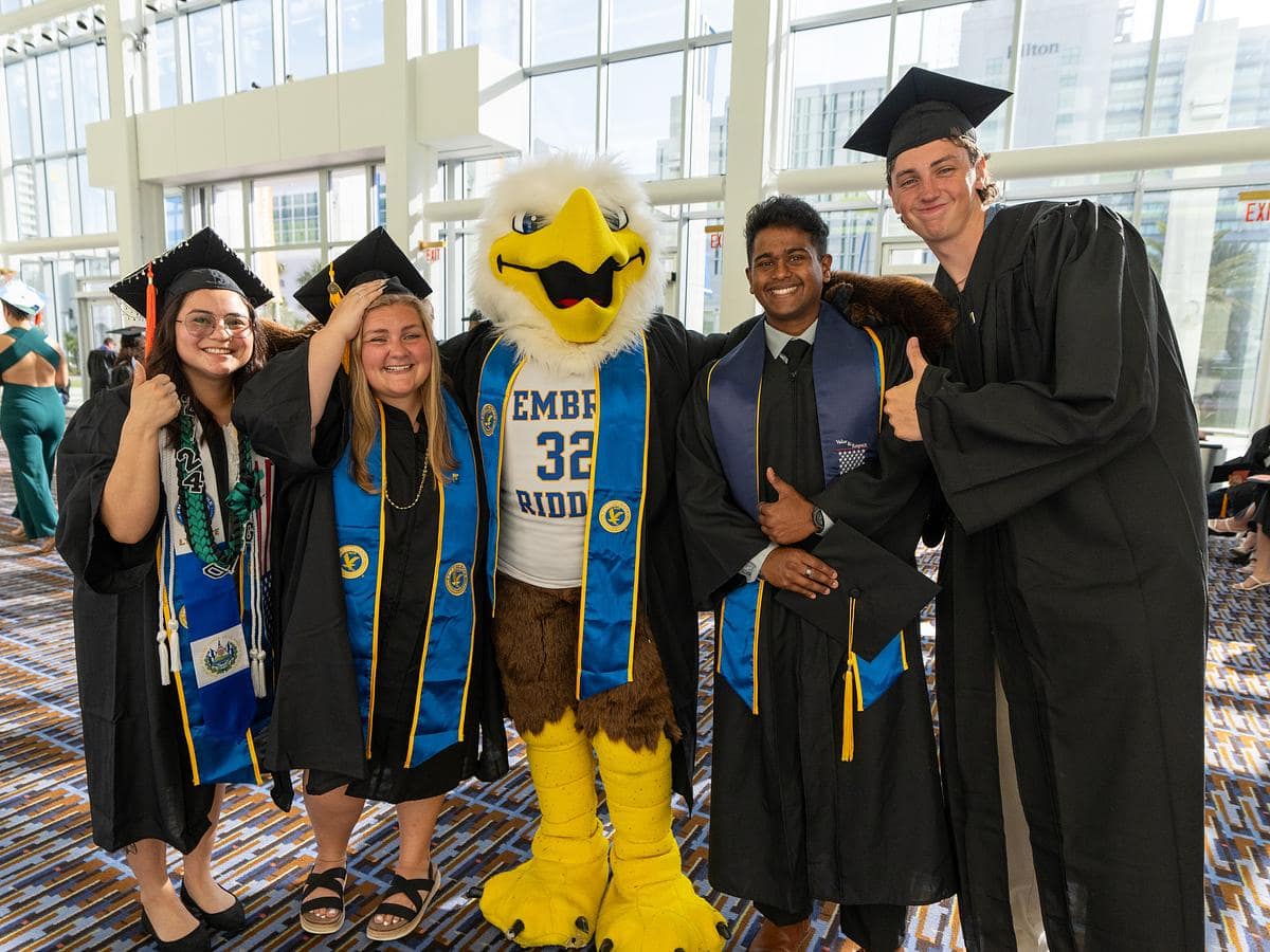 Graduates pose with Eagle mascot