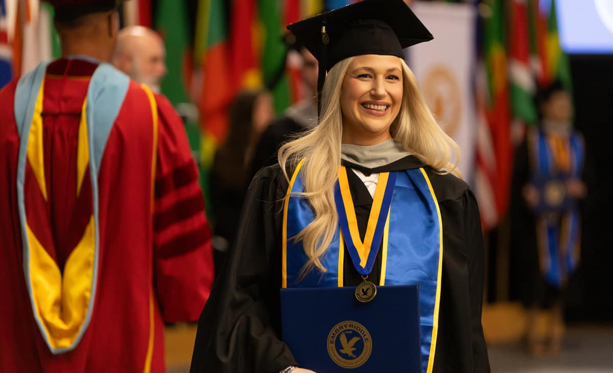One of the more than 450 Embry-Riddle Worldwide Campus graduates receives her diploma at a May 31 commencement ceremony
