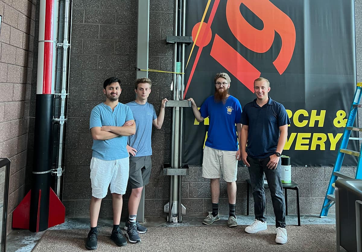 Gaurav Nene, Cooper Eastwood, William Knoblauch and David Hadley pose in Embry-Riddle's Aerospace Experimentation and Fabrication Building with their reusable suborbital rocket.