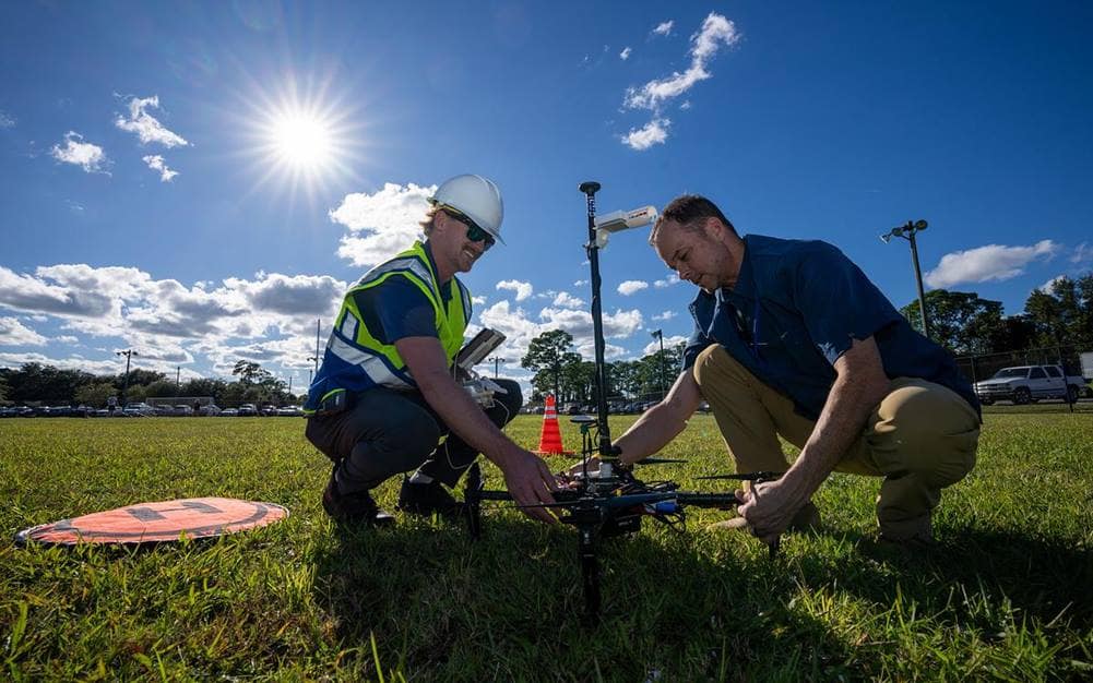 Graduate student Jeremy Copenhaver and Dr. Marc Compere prepare a drone for launch on Embry-Riddle’s Daytona Beach Campus