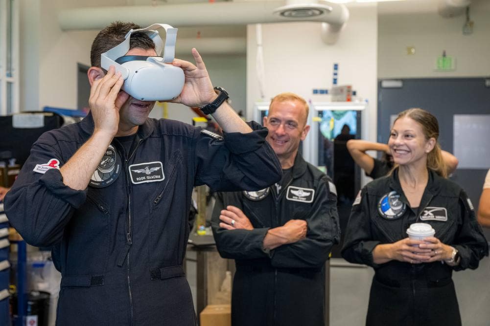 Polaris Dawn Mission Commander Jared Isaacman looks through a virtual reality headset to see test footage from the LLAMAS camera unit