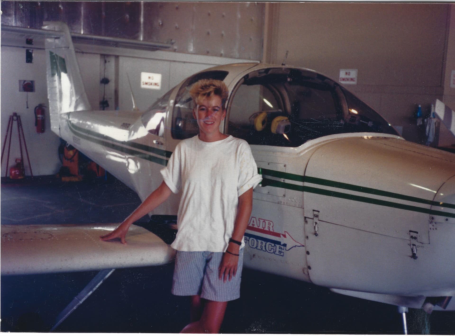 Woman standing next to a plane