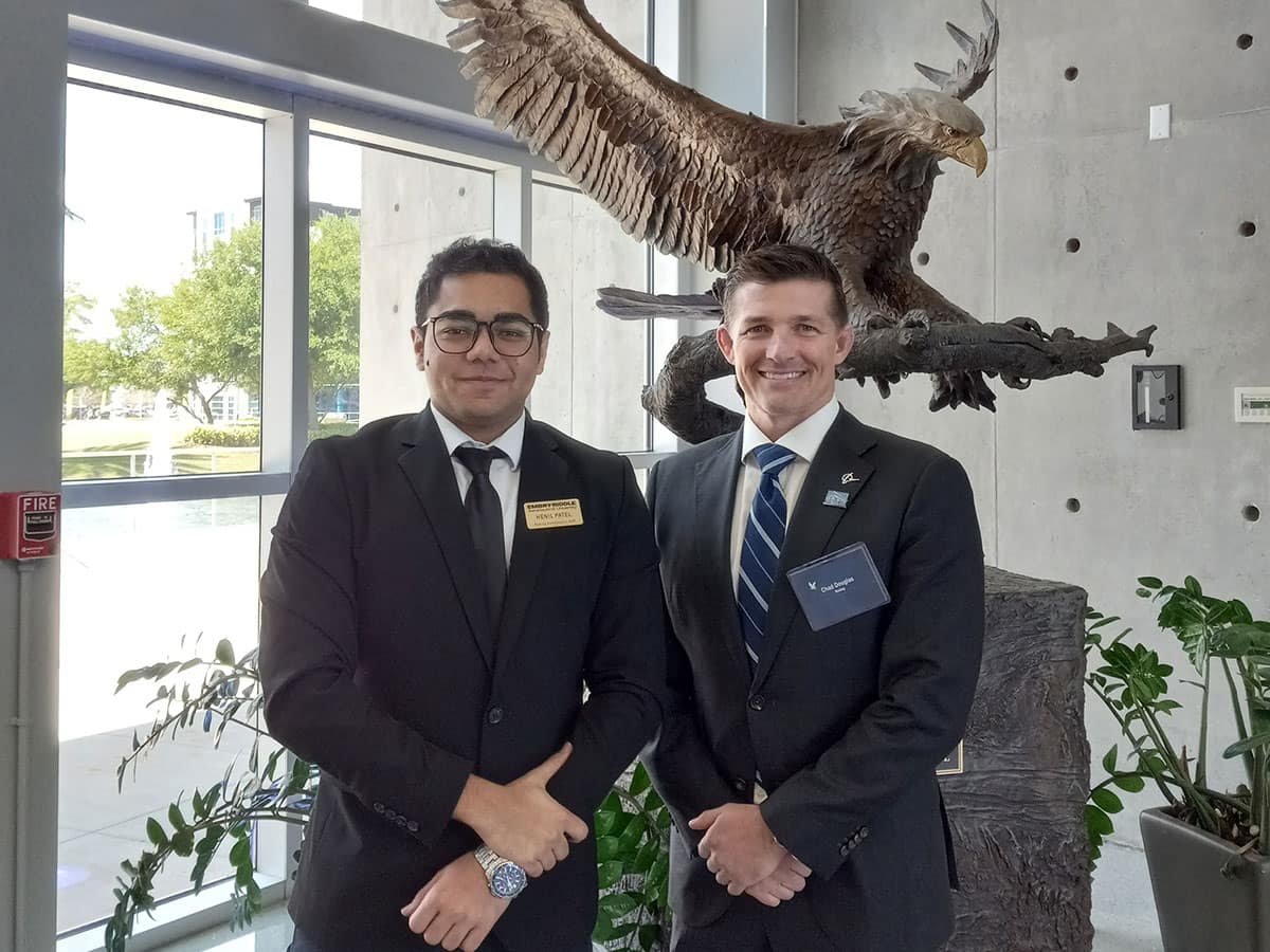 Aerospace Engineering senior Henil Patel (left) stands with alumnus Chad Douglas