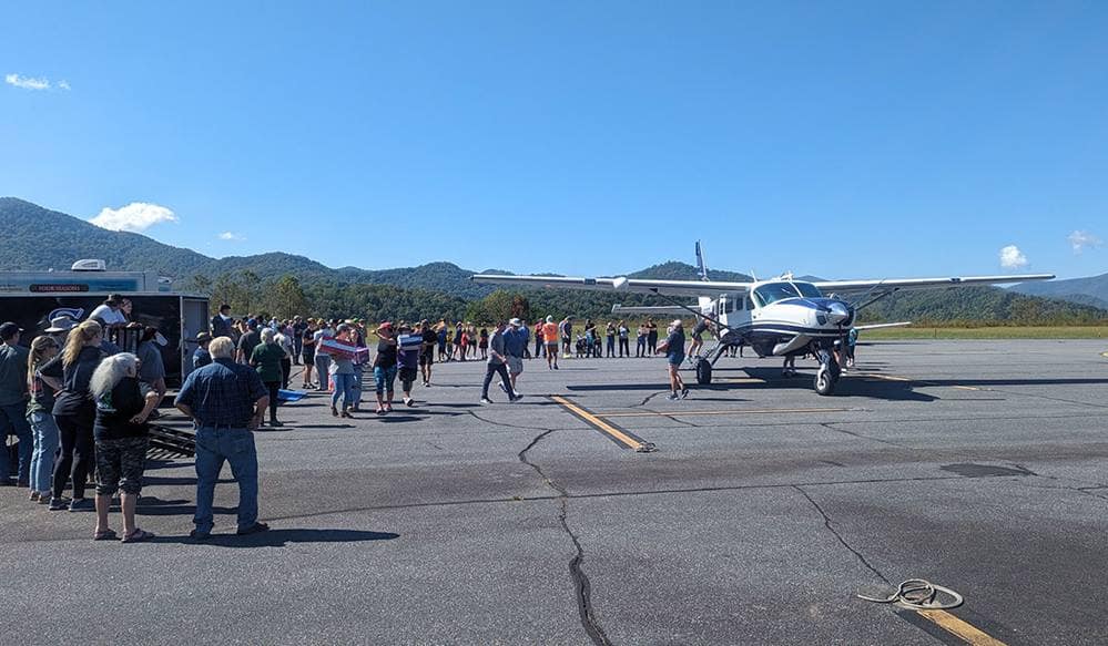 Volunteers at a bucket brigade to airlift essential supplies at the Jackson County, North Carolina, airport