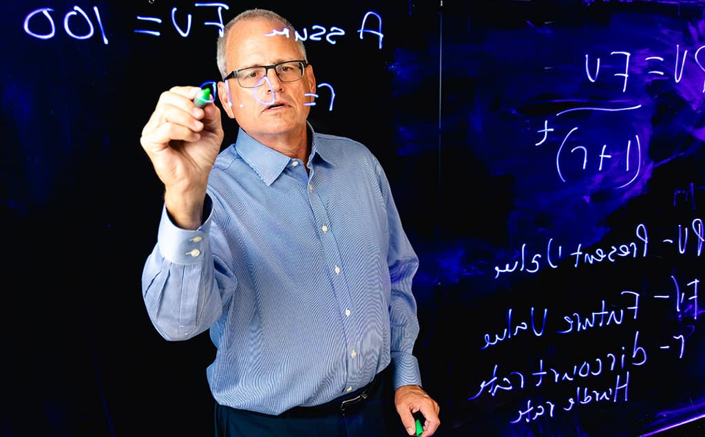 Teacher writing on a board.