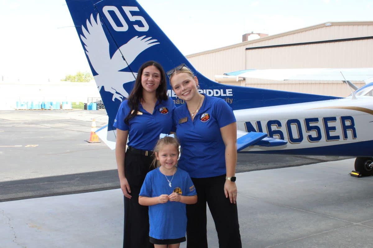 Women in Aviation student leaders welcome a young participant during Girls in Aviation Day at the Prescott Campus.
