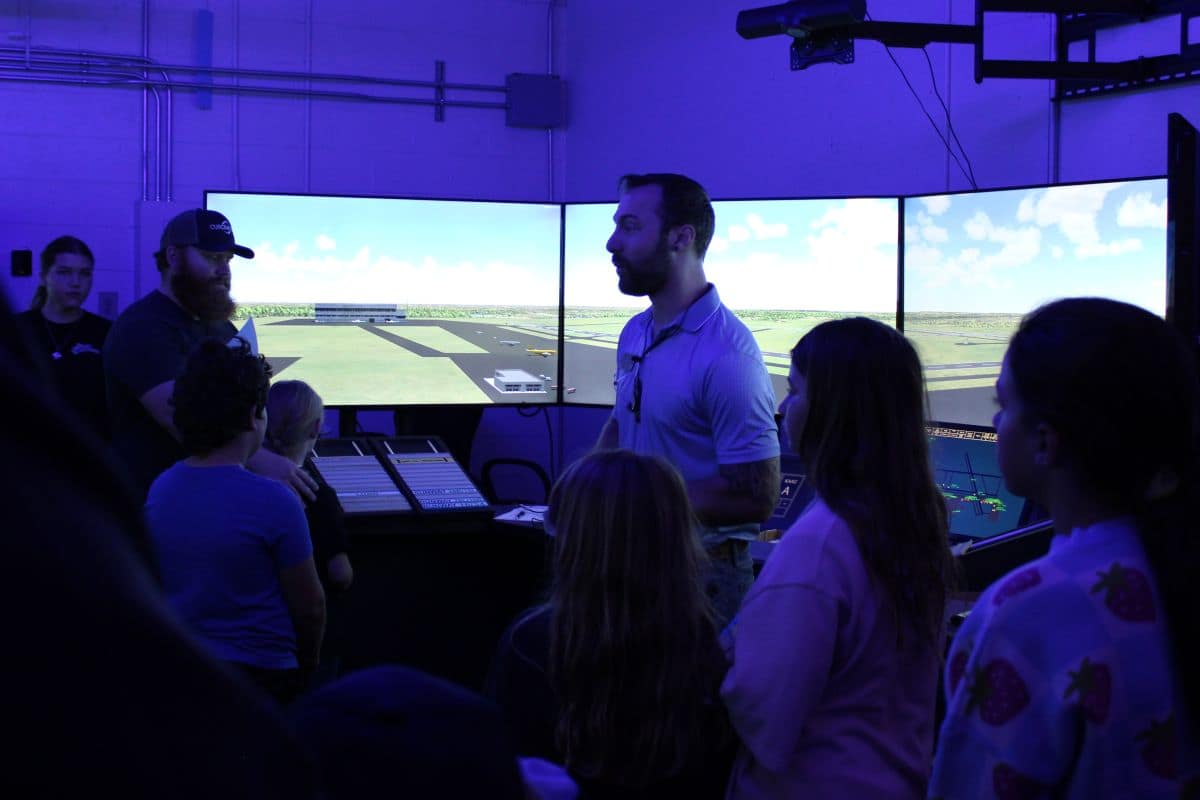 Professor Kyle Wilkerson leads an air traffic control demonstration for visiting students during Girls in Aviation Day.