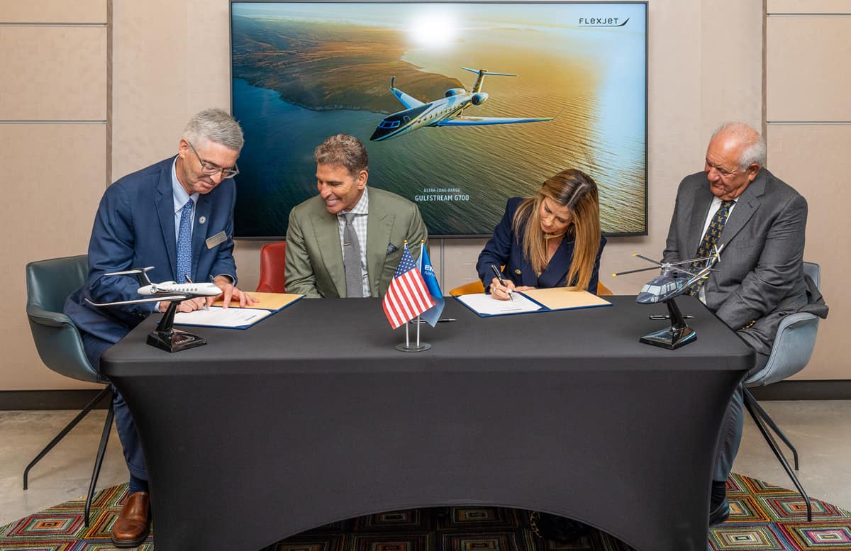Kenn and Pamela Ricci, Presdient Butler and Mori Hosseini sign an agreement.
