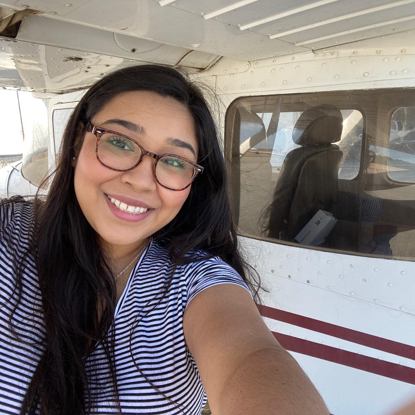 Marily Aguilar-Hernandez stands by a plane