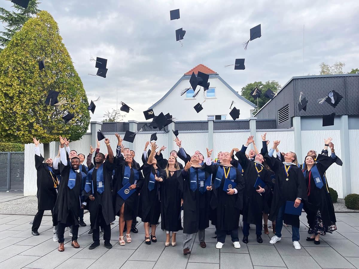 Embry-Riddle students throwing their graduation caps in the air