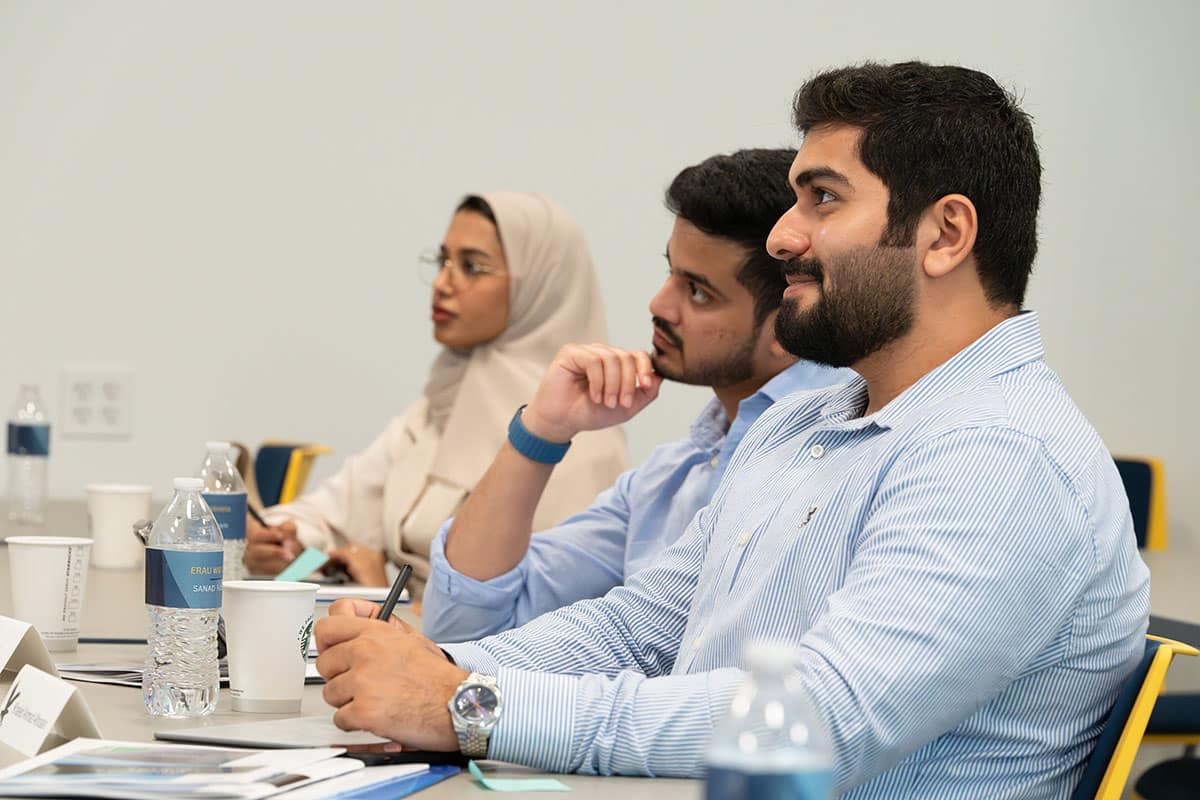 Three people sitting at a table