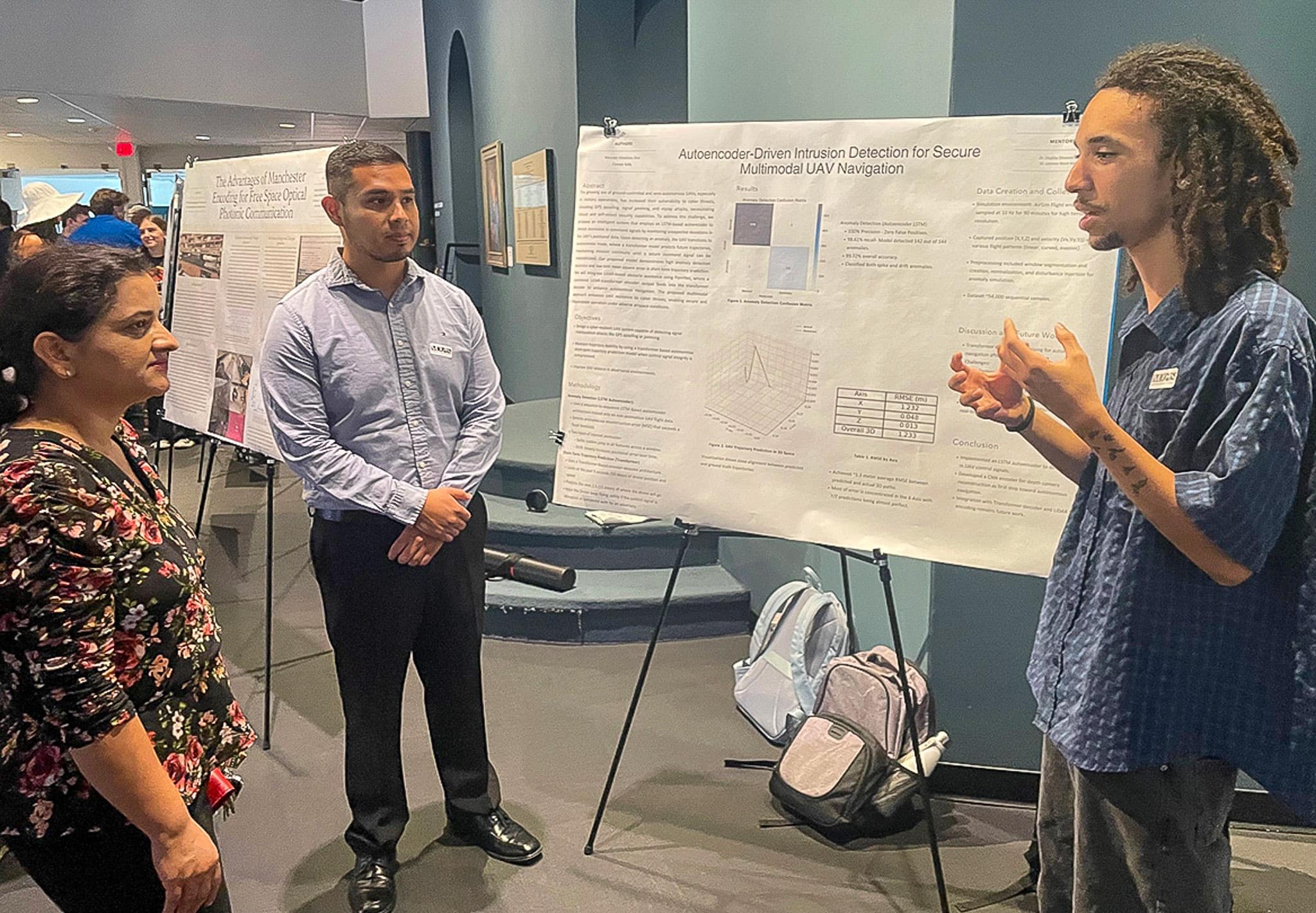 Connor Kelly presents his UAV cybersecurity research to Dr. Kandel in a poster session at the Embry Riddle Undergraduate Research Showcase at the Museum of Arts and Sciences in July.