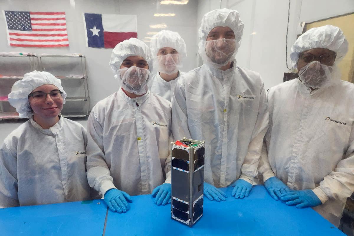 An Embry-Riddle team prepares to integrate the student-built CubeSat EagleSat-2 into a deployer. EagleSat-2 is scheduled to hitch a ride to space aboard a Northrop Grumman rocket this fall.