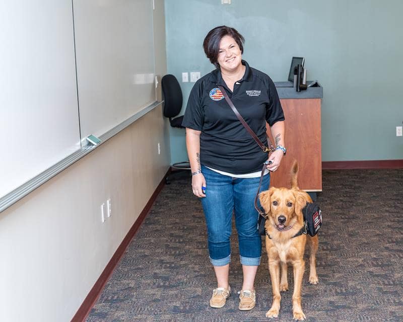 Graduate student and Army veteran Amanda Meurer helps teach new student veterans in the UNIV 101 course with her service dog, Mako, by her side.