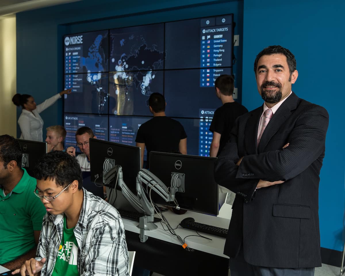 Dr. Remzi Seker in a classroom with students.