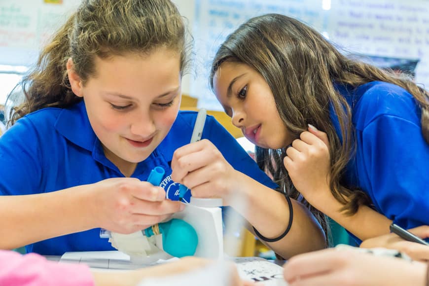 Arden Egle and Ayla Ghaffarian decorate their balloon-powered car and make final adjustments prior to testing at Cypress Creek Elementary School