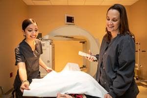 Aerospace Physiology major Haleema Irfan, left, works in the nuclear medicine area with Karen Steiner, diagnostic imaging supervisor. (Photo: David Massey/Embry-Riddle)