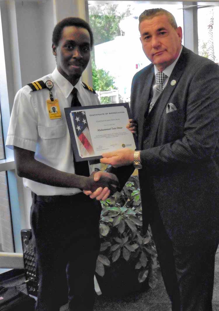 Flight Instructor Muhammad Omar receives an FAA Safety Award from FAA Orlando Flight Standards District Office Manager Max McConnell.
