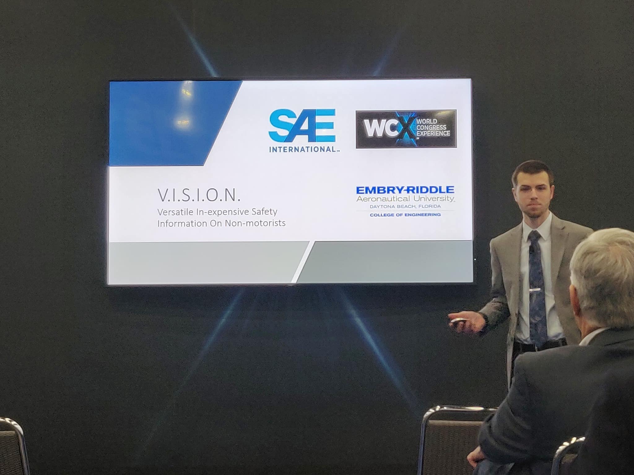 Andrew Ferree presents his and Zack Siadman’s idea for a vehicle-to-bicycle communication device to executives at the SAE International’s Connected Vehicle Challenge 2019, where the duo won 2nd place overall. (Photo: Zack Saidman)