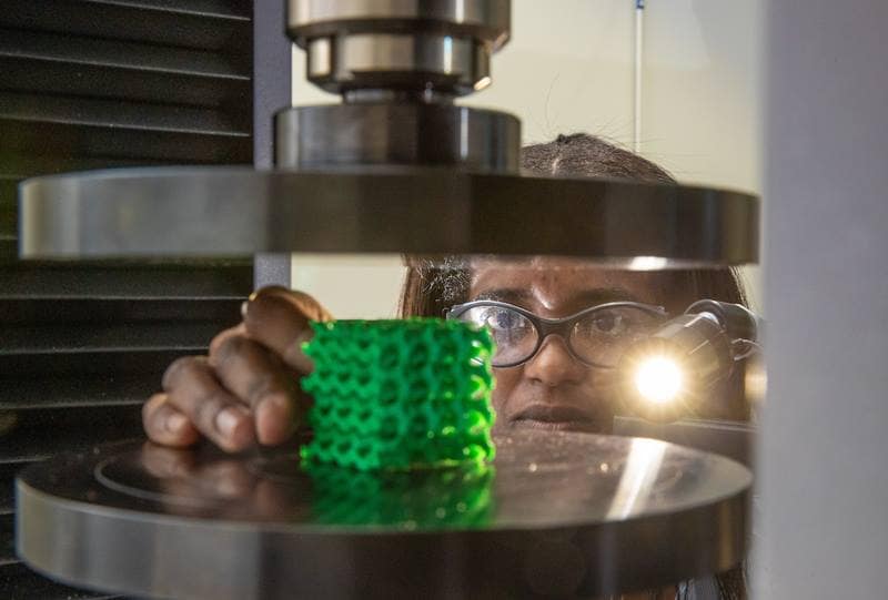One of Dr. Ali Tamijani’s students, Rossana Fernandes, positions a honeycomb sample object to test the performance of optimized cellular structures in the Structures Lab at Embry-Riddle’s MicaPlex facility. (Photo: Embry-Riddle/David Massey)