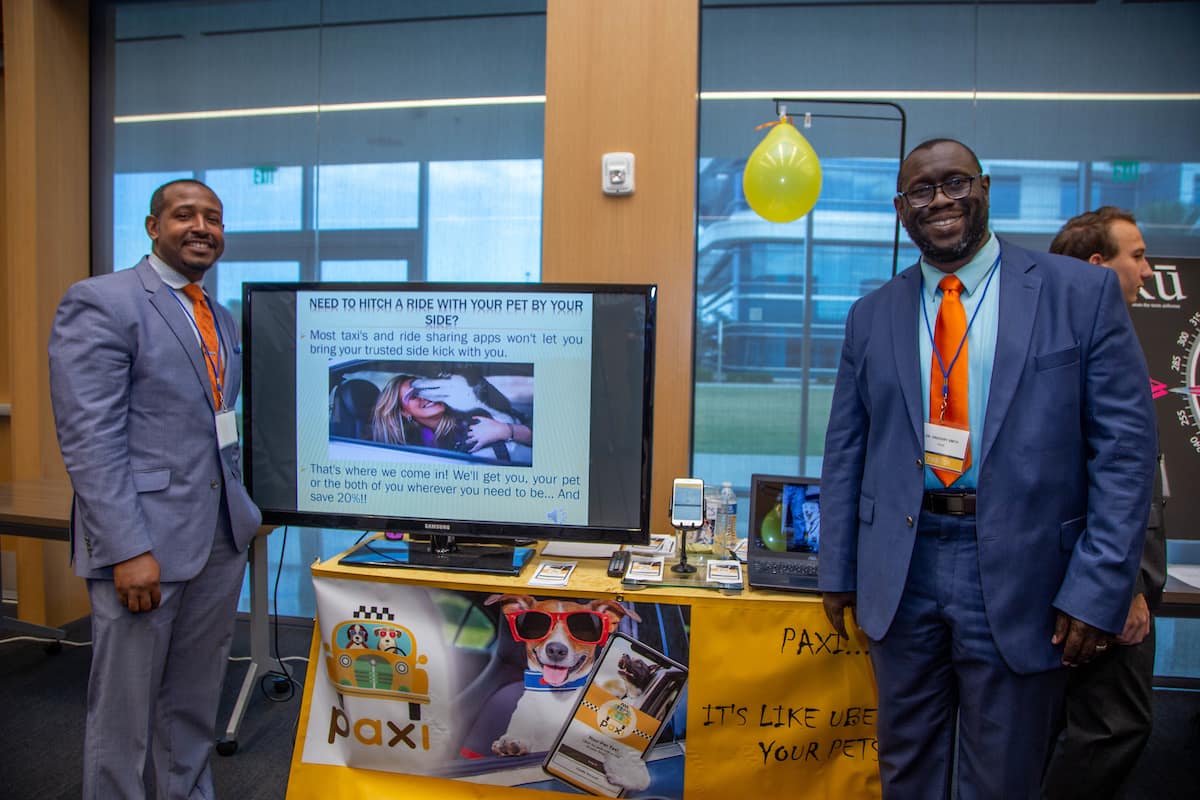 Alumnus Greg Smith (right) and partner Dwight Bermingham (left) accepted a check for $1,500 for winning one of two top prizes at the 2019 TREP Expo innovation competition.