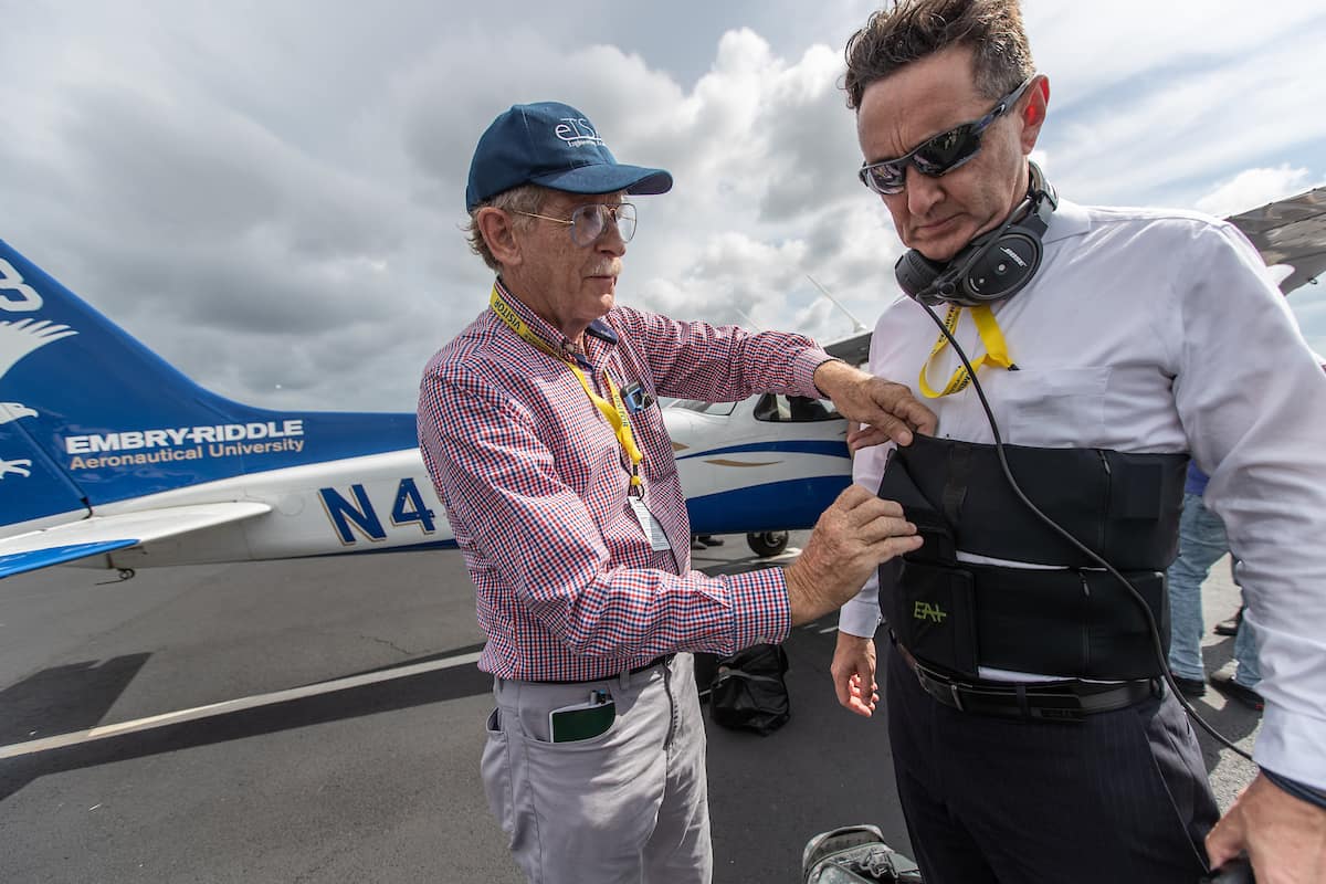 Dr. Angus Rupert, medical research scientist with the U.S. Army Aeromedical Research Laboratory, helps outfit Dr. Braden McGrath, Research Professor for Validated Mathematical Model of Spatial Disorientation, with a tactile belt that will transmit vibrations onto his torso during flight to keep him oriented, no matter what the visual conditions. 