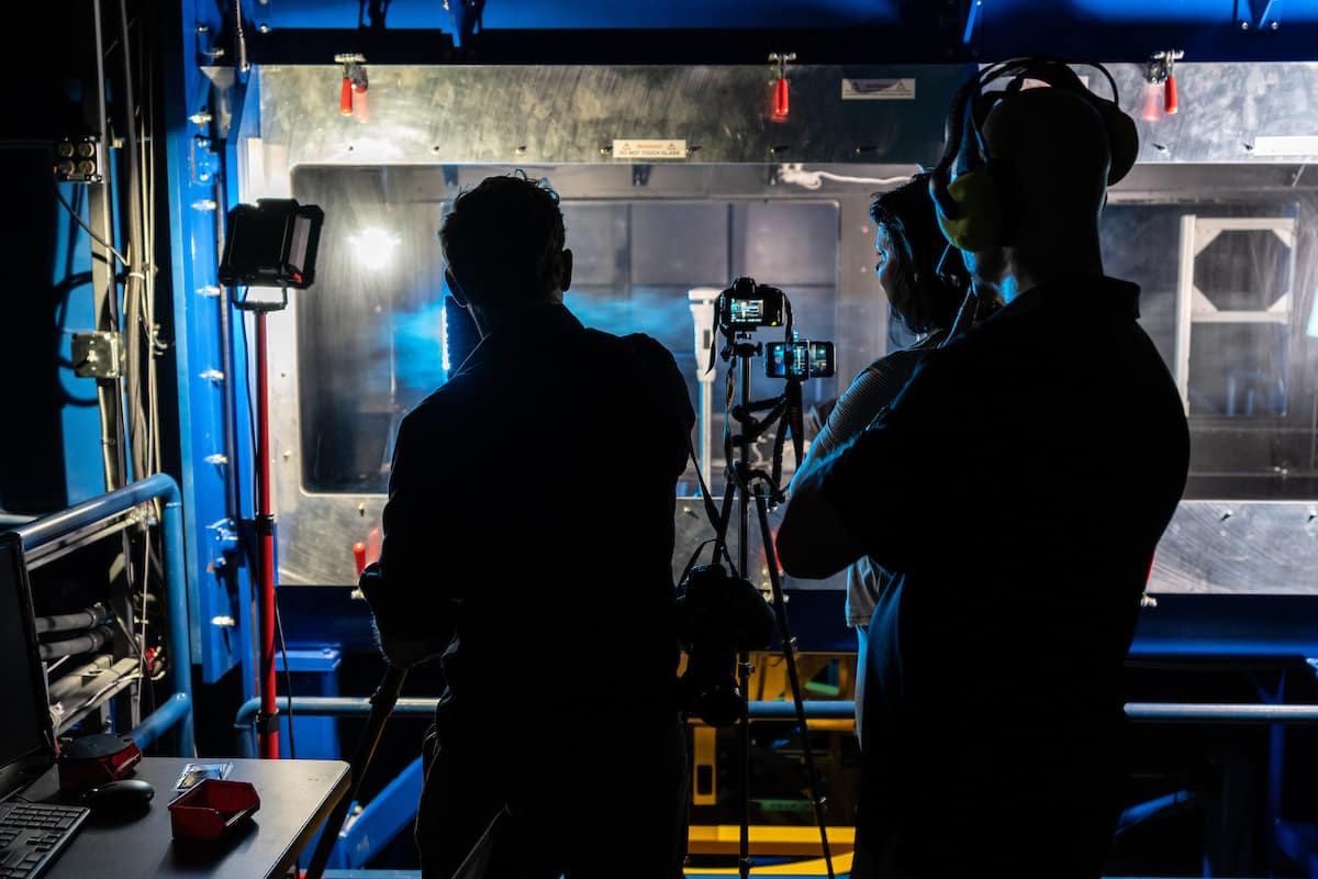 David St. John, technical product lead for WeatherFlow Inc., affixes the Tempest weather station inside the Subsonic Wind Tunnel Facility at the Micaplex, and then records his findings. (Photo: Embry-Riddle/David Massey)