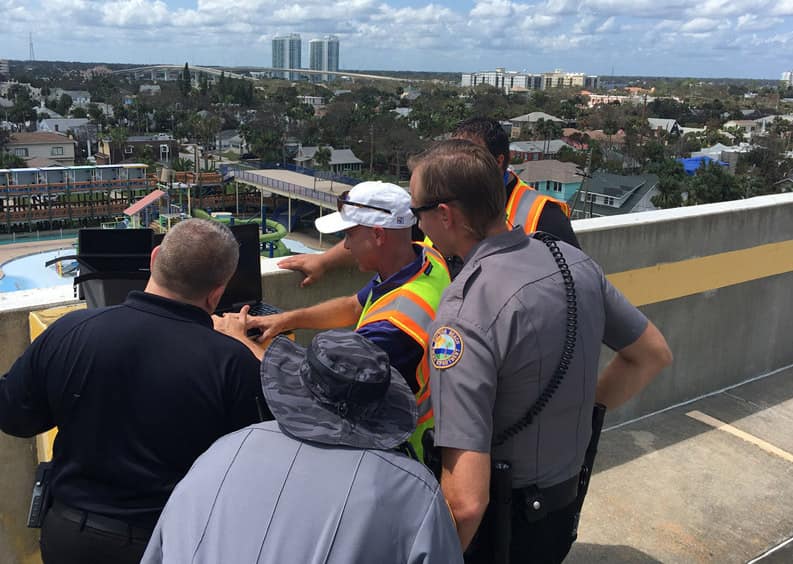 Dr. Joseph Cerreta (yellow vest) teaches police officers from the Daytona Beach Police Department, in Florida, how to conduct a post-hurricane damage assessment with a senseFly eBee after Hurricane Irma. (Photo: ERAU Assistant Professor Anthony Galante)
