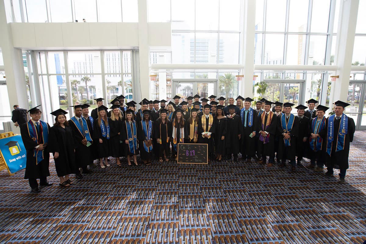 Students gather from the The David B. O'Maley College of Business at Embry-Riddle Aeronautical University after commencement at the Ocean Center in Daytona Beach on May 3, 2019.