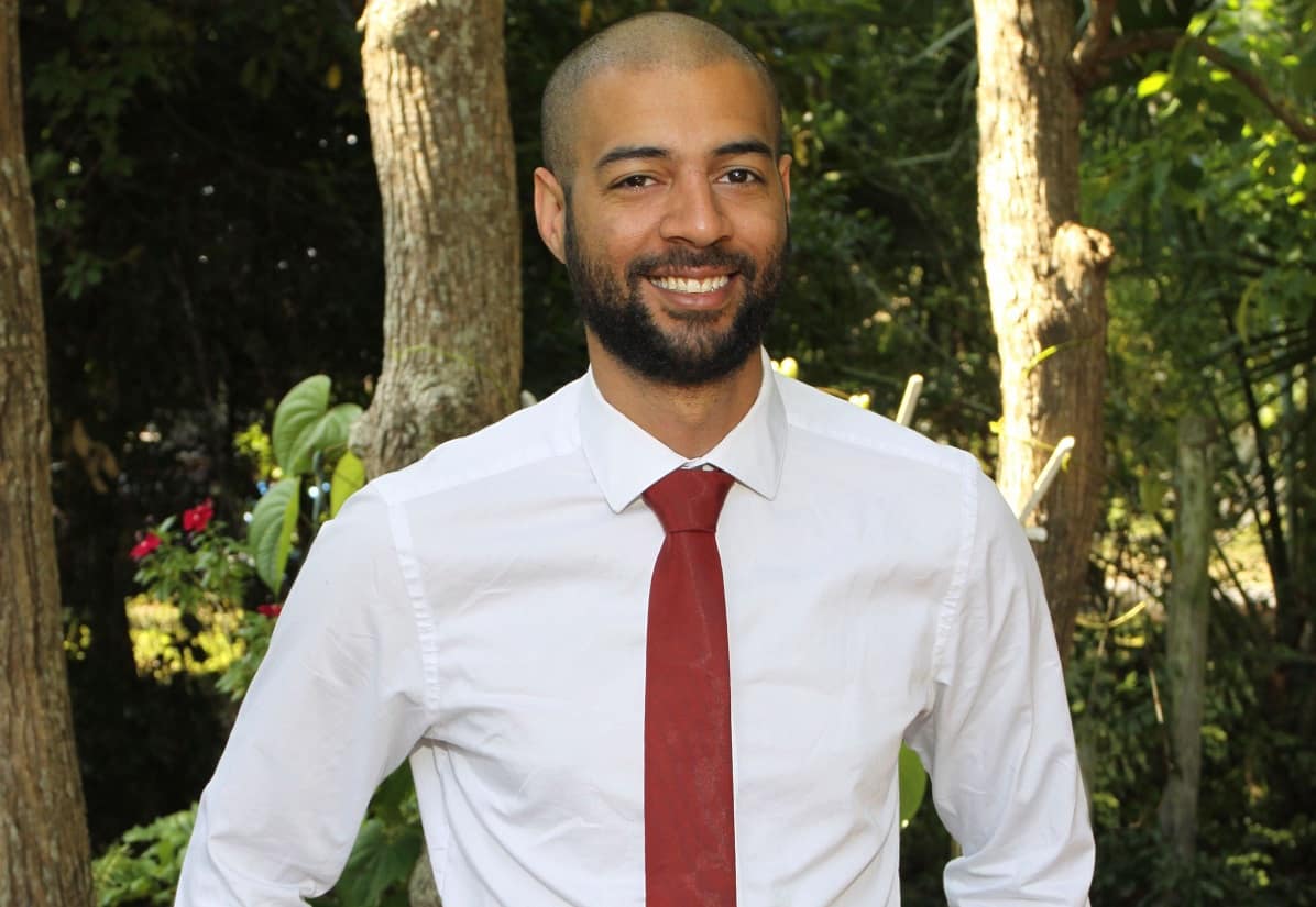 portrait of Eli Ellison standing near trees