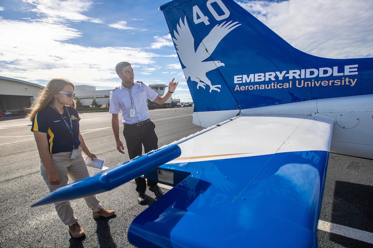 Embry-Riddle students Tyler Rispoli, a flight instructor, and Sydney Pilling complete a pre-flight inspection on an aircraft. Both are members of the Eagles Flight Team