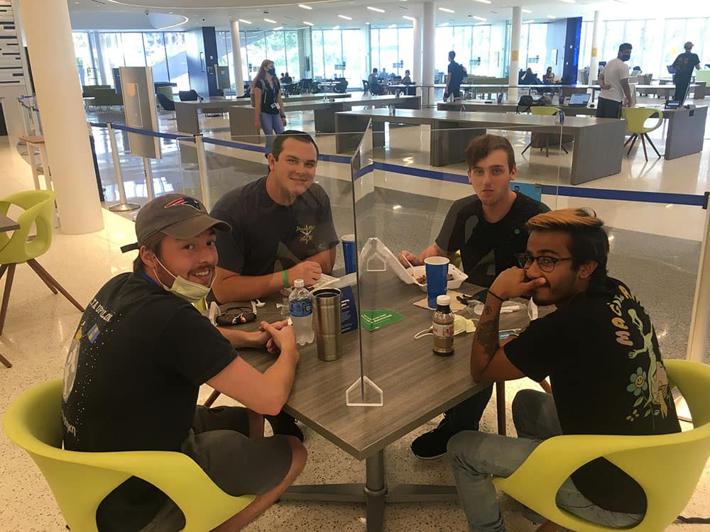 New Plexiglas barriers let Embry-Riddle students briefly remove their required face coverings to share food, fun and fellowship.