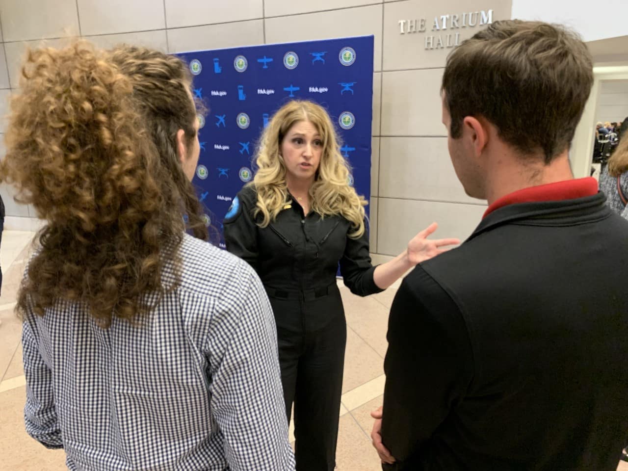 Embry-Riddle students Max Cannon and Noah Eudy meet Virgin Galactic Chief Astronaut Instructor Beth Moses at the 2020 Commercial Space Transportation Conference held in January in Washington, D.C.