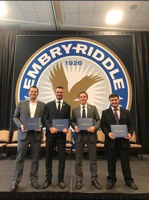 Diogo Youssef, João Centeno, Luciano Figueiredo Vale de Oliveira, and Fabiano Gomes de Oliveira receive their Aviation Management diplomas from Embry-Riddle’s South America Campus.