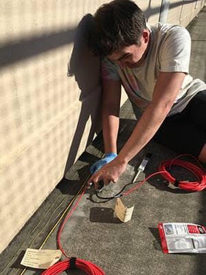 Master’s student Parker Brooks works with sensing equipment in a Civil Engineering lab on the Daytona Beach Campus. (Photo: Parker Brooks)